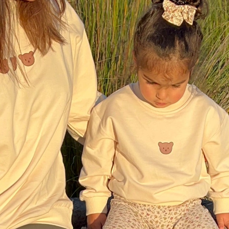 mother and daughter matching cream jumper with teddy face on the front in cream colour 